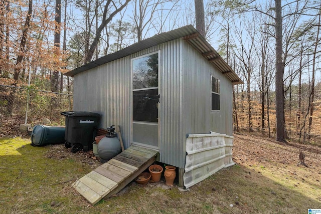 view of outdoor structure with an outbuilding and fence