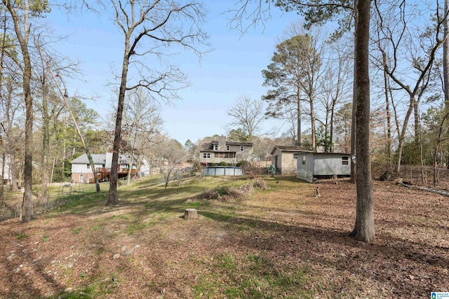 view of yard with fence and an outbuilding