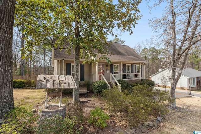 view of front of home with stairs, a porch, and roof with shingles