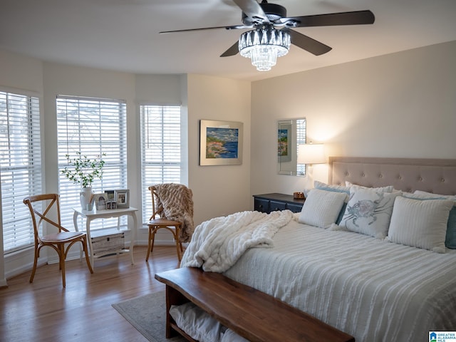 bedroom with baseboards and wood finished floors