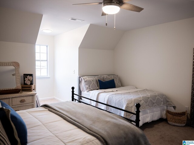 carpeted bedroom featuring lofted ceiling, ceiling fan, visible vents, and baseboards