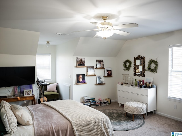 bedroom featuring carpet, multiple windows, and lofted ceiling