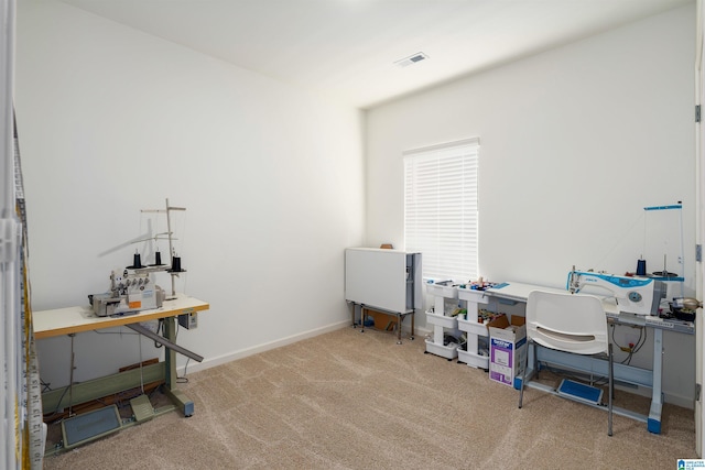 carpeted office space featuring baseboards and visible vents