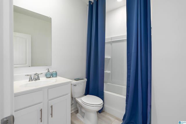 bathroom with vanity, shower / tub combo, and toilet