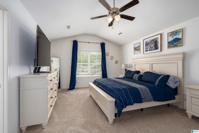 bedroom with visible vents, light colored carpet, a ceiling fan, and vaulted ceiling