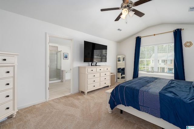 bedroom with visible vents, light carpet, ensuite bath, and vaulted ceiling