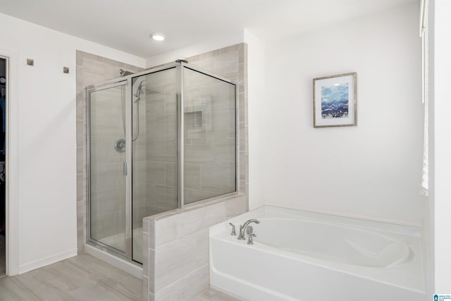 bathroom with a garden tub and a stall shower