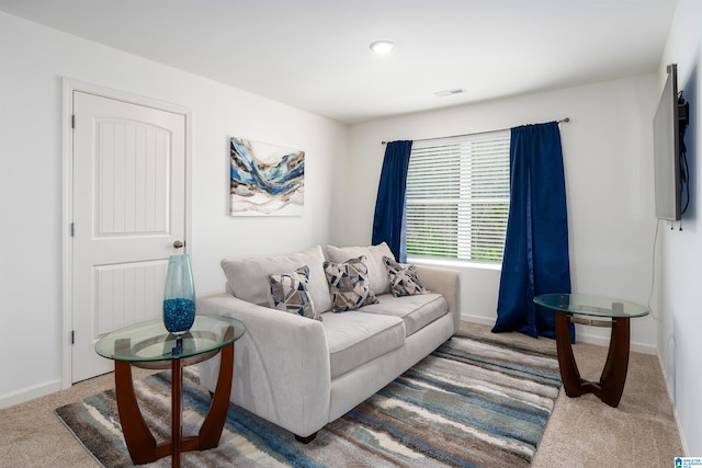 living room with visible vents, baseboards, and carpet flooring