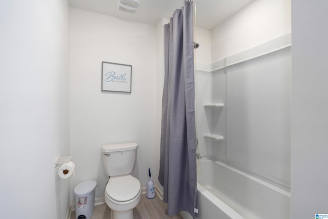 full bathroom with shower / tub combo, toilet, baseboards, and visible vents