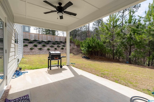 view of patio / terrace with area for grilling, a ceiling fan, and fence