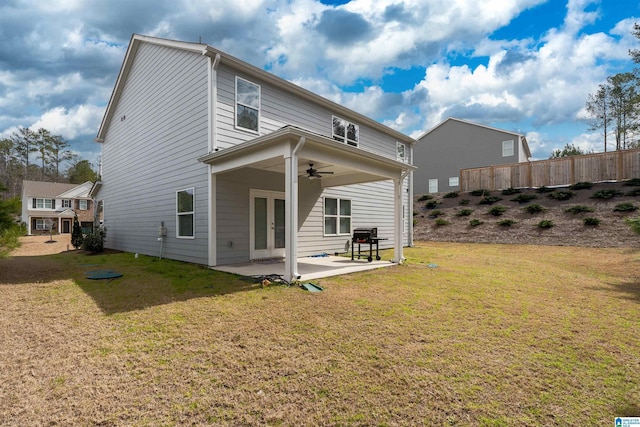 back of house featuring a ceiling fan, fence, french doors, a patio area, and a lawn