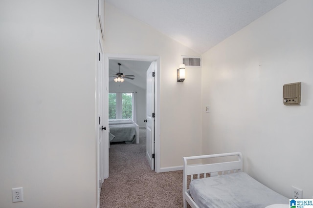 bedroom with lofted ceiling, baseboards, visible vents, and carpet flooring