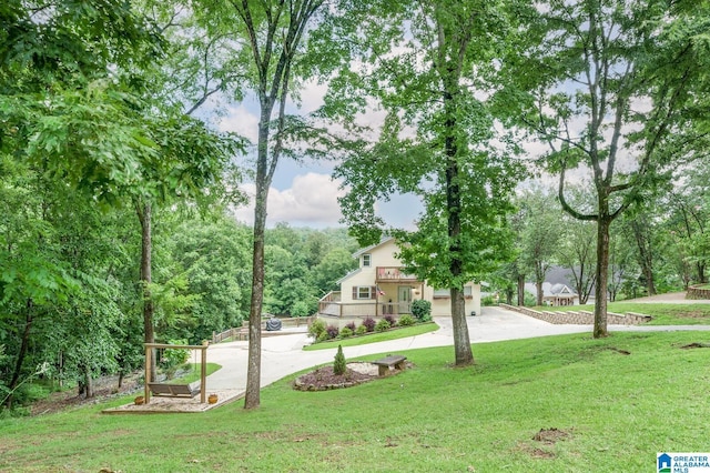 view of property's community with a lawn and driveway