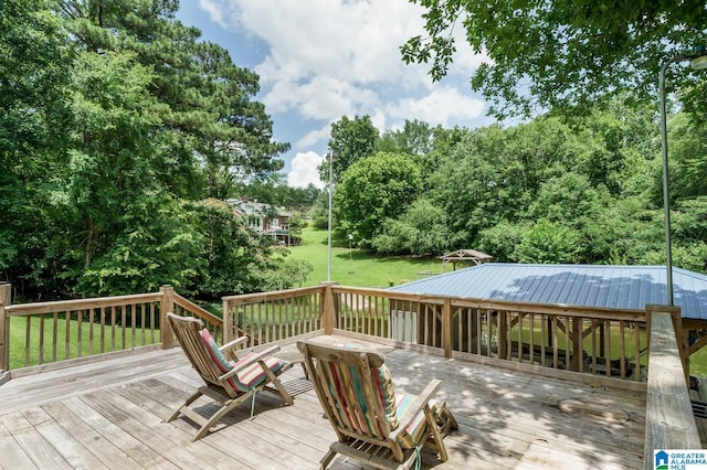 wooden terrace featuring a lawn