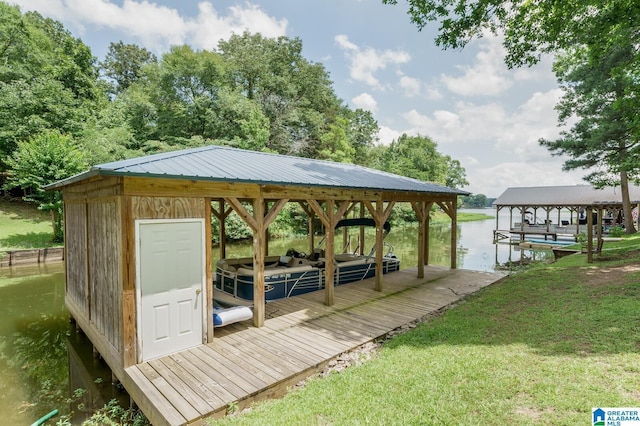 dock area with a lawn and boat lift