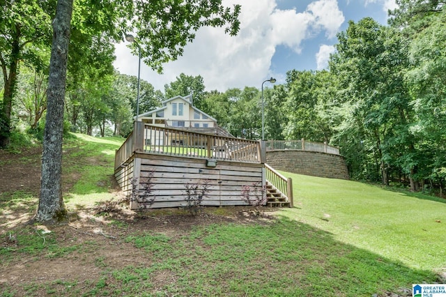 back of property with a yard, stairway, and a wooden deck