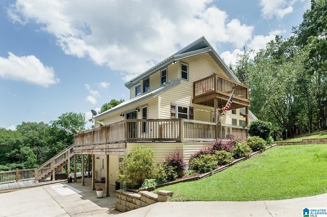 view of home's exterior with stairs, a yard, a deck, and a patio area