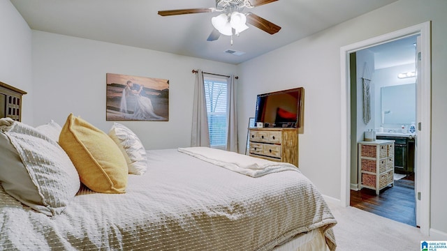 bedroom featuring visible vents, baseboards, ensuite bath, ceiling fan, and carpet floors