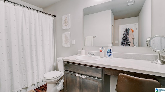 bathroom featuring toilet, visible vents, and vanity