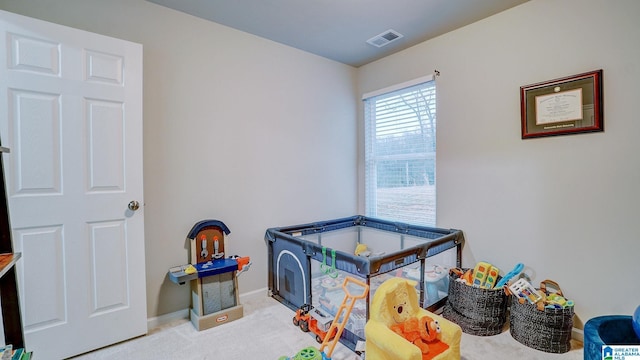 recreation room featuring carpet floors, baseboards, and visible vents