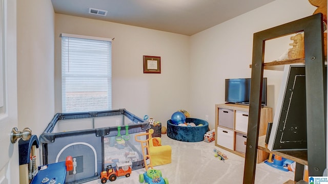 rec room featuring visible vents and carpet flooring