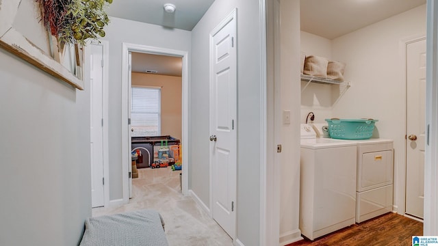 washroom with laundry area, washer and clothes dryer, and baseboards