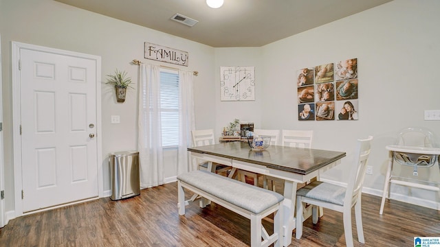 dining space featuring visible vents, baseboards, and wood finished floors