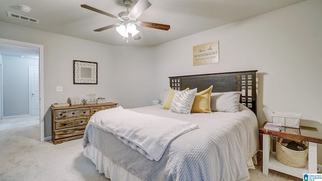 bedroom with visible vents, ceiling fan, and light carpet