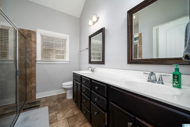 full bath with a sink, toilet, and a shower stall