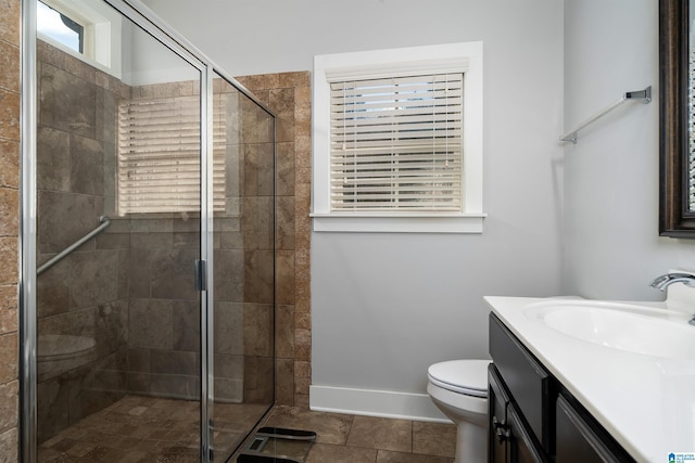 full bathroom with tile patterned flooring, a shower stall, baseboards, toilet, and vanity