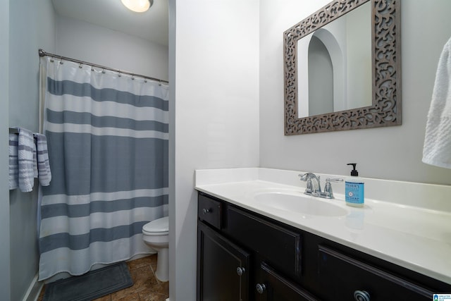 bathroom featuring stone finish floor, curtained shower, toilet, and vanity