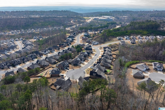 bird's eye view featuring a residential view and a wooded view