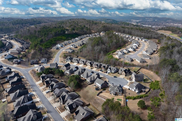 birds eye view of property featuring a residential view and a wooded view