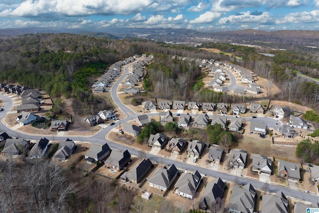 aerial view featuring a wooded view and a residential view