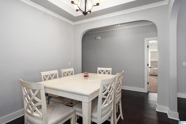 dining room with crown molding, baseboards, dark wood-style floors, an inviting chandelier, and arched walkways