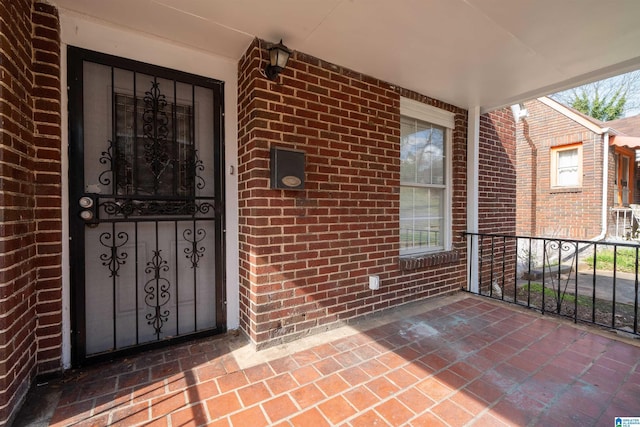 entrance to property with brick siding