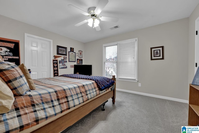 carpeted bedroom featuring baseboards, visible vents, and a ceiling fan