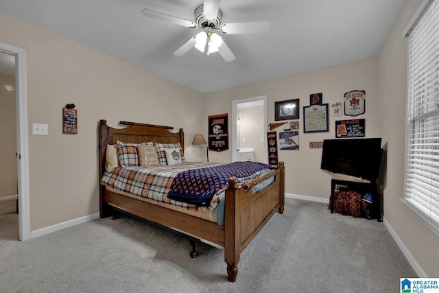 carpeted bedroom with ceiling fan and baseboards