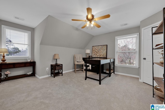 carpeted home office featuring a wealth of natural light, visible vents, and baseboards