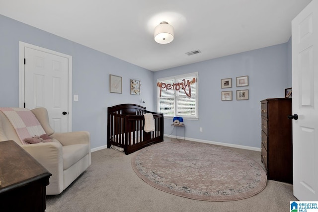 carpeted bedroom with a nursery area, baseboards, and visible vents