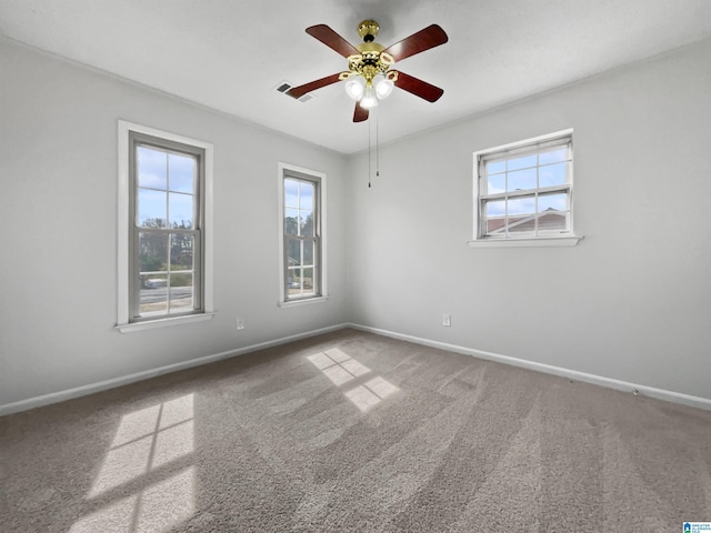 carpeted spare room with baseboards and a healthy amount of sunlight