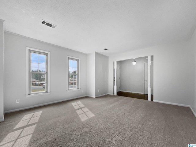 carpeted empty room featuring visible vents and baseboards