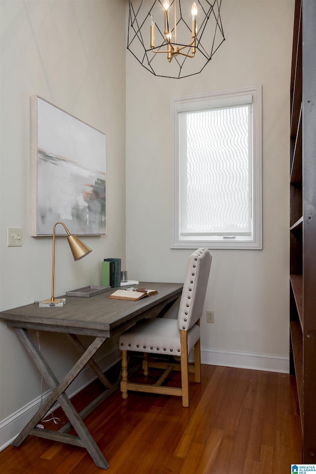 dining room with an inviting chandelier, baseboards, and wood finished floors