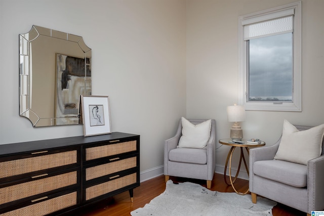 sitting room featuring baseboards and wood finished floors