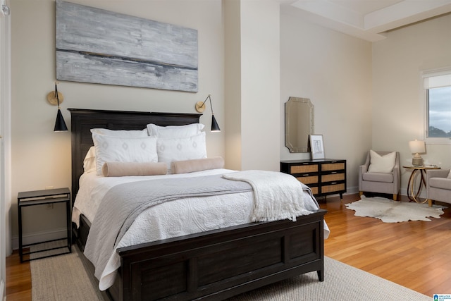 bedroom featuring light wood-type flooring and baseboards