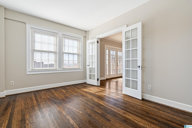 unfurnished room featuring french doors, dark wood finished floors, and baseboards