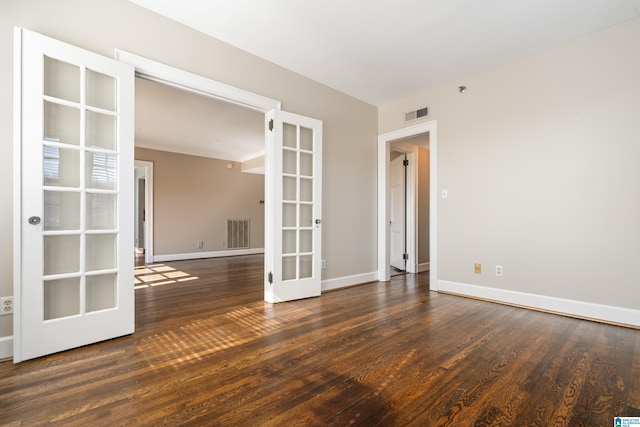 unfurnished room featuring french doors, wood finished floors, visible vents, and baseboards