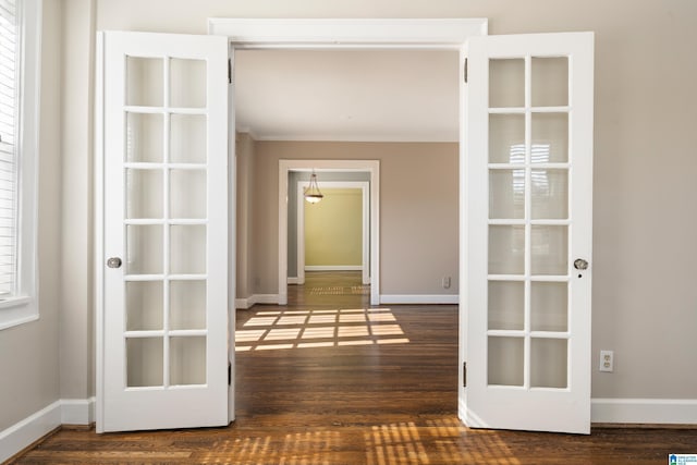 hall featuring crown molding, wood finished floors, and baseboards