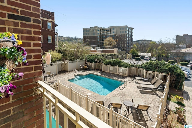 pool with a patio area and a fenced backyard