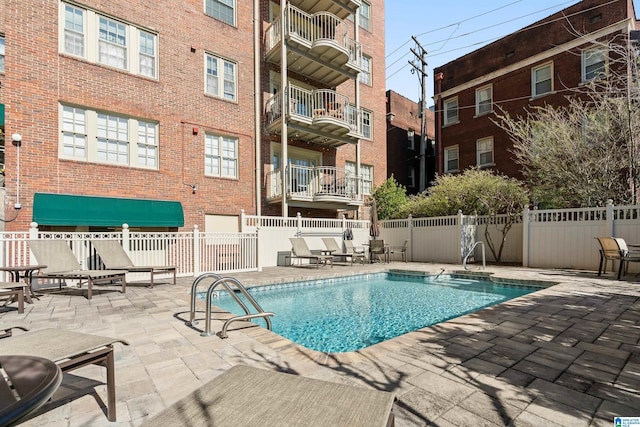 community pool featuring fence and a patio